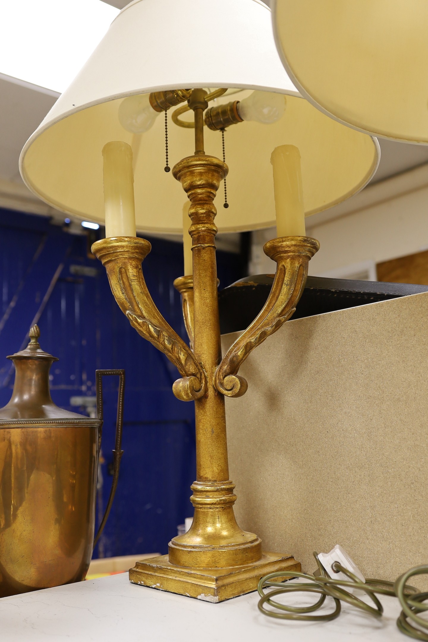 A pair of giltwood three branch lamps, 76 cms high